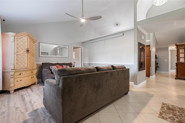 living room with light tile patterned floors, ceiling fan, and high vaulted ceiling