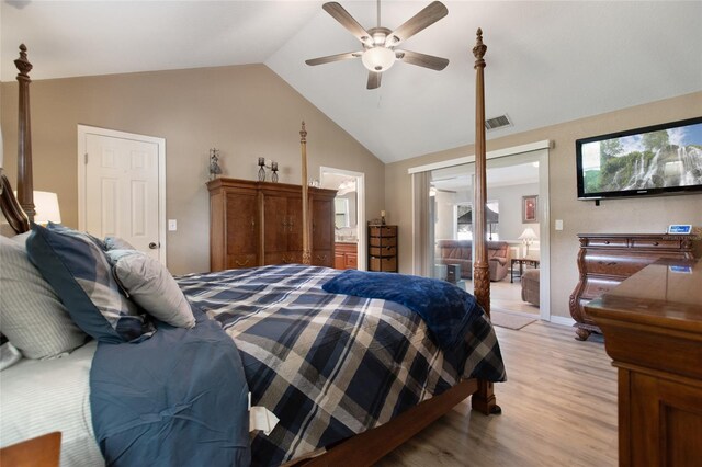 bedroom featuring light wood-type flooring, vaulted ceiling, ceiling fan, and a closet