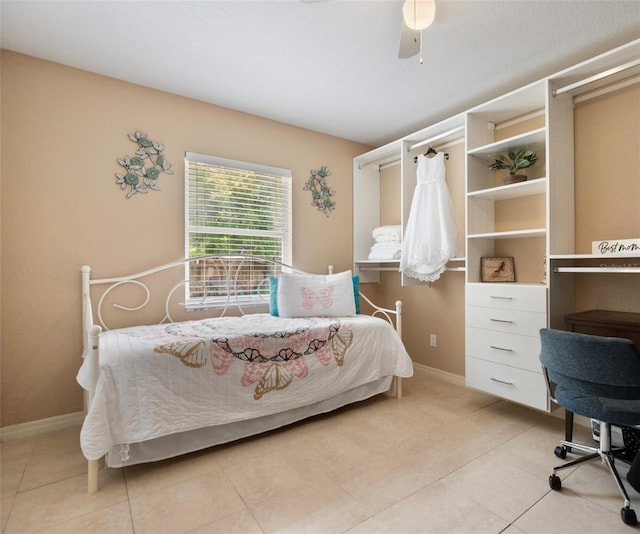 tiled bedroom featuring ceiling fan