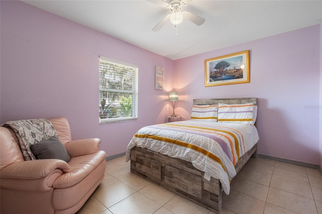 tiled bedroom featuring ceiling fan