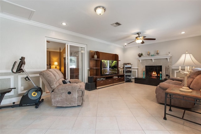 living room with ceiling fan, light tile patterned floors, and ornamental molding