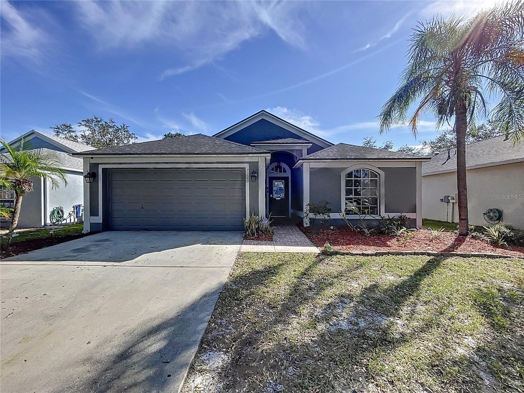 ranch-style home with a garage and a front yard