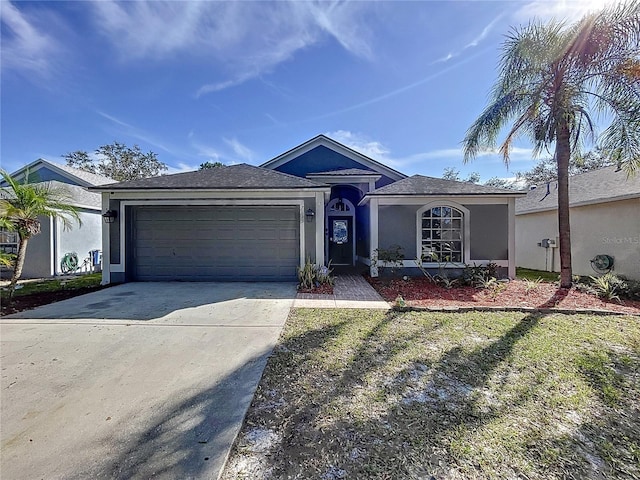 ranch-style home with a garage and a front yard