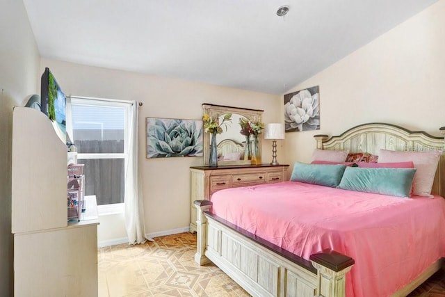 bedroom with lofted ceiling and light tile patterned flooring