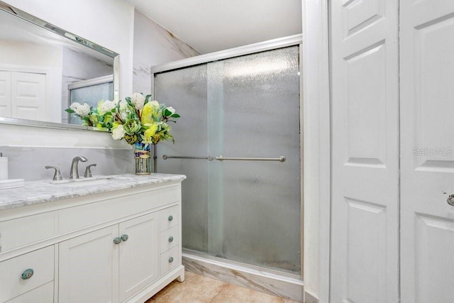 bathroom with tile patterned flooring, vanity, and an enclosed shower