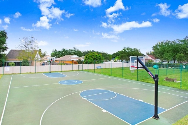 view of sport court with a yard