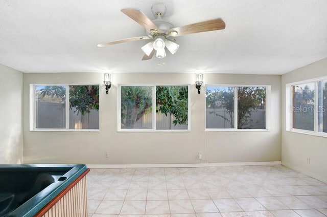 unfurnished room with ceiling fan and light tile patterned floors