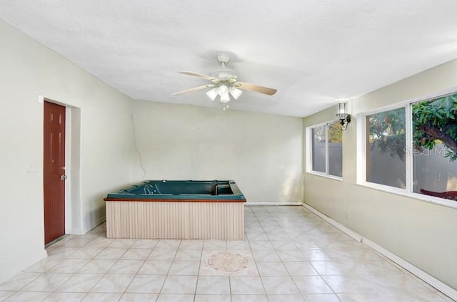 interior space with ceiling fan