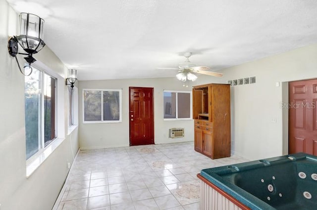 interior space with a wall mounted AC, light tile patterned floors, ceiling fan, and billiards