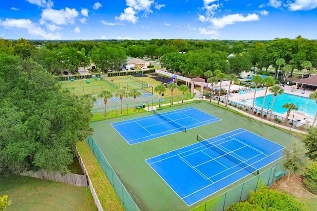 view of sport court featuring a community pool