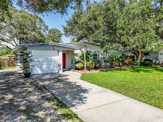 single story home with a garage and a front lawn