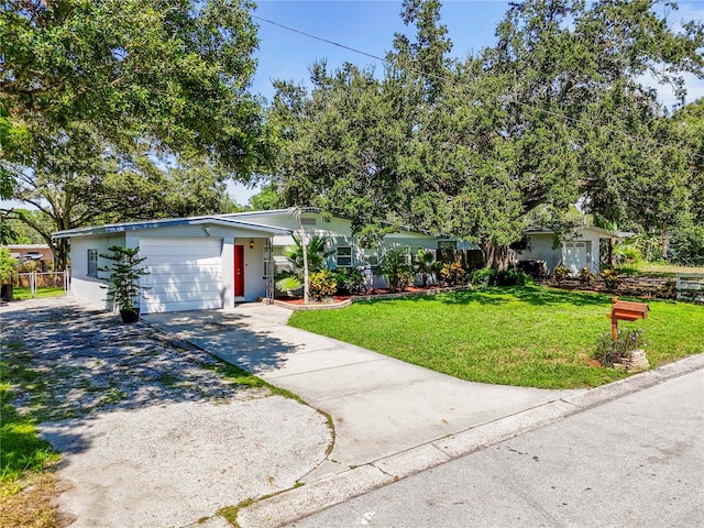 ranch-style house with a garage and a front lawn