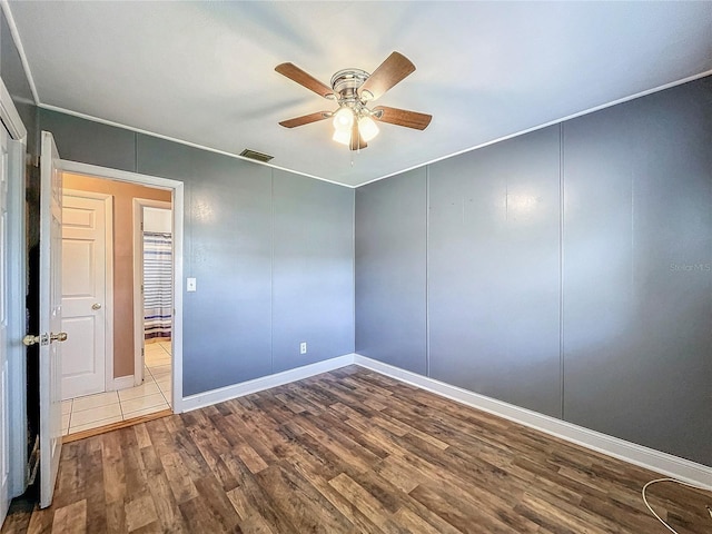 empty room featuring ceiling fan and hardwood / wood-style floors