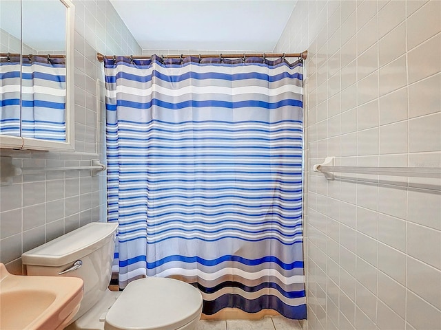 bathroom with tile walls, a shower with curtain, tile patterned floors, and toilet