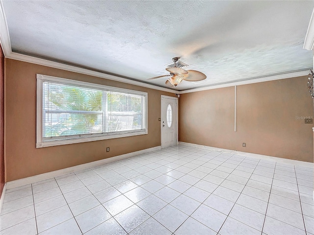 spare room with a textured ceiling, ceiling fan, light tile patterned floors, and crown molding