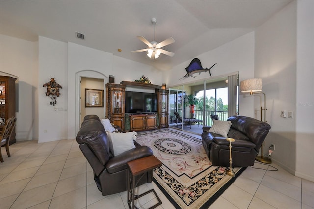 living room with light tile patterned flooring, ceiling fan, and vaulted ceiling