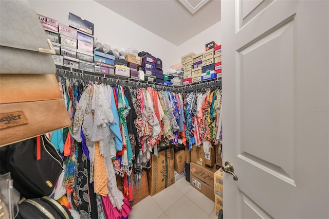 walk in closet with light tile patterned floors