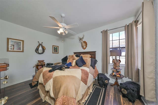 bedroom with dark wood-type flooring and ceiling fan