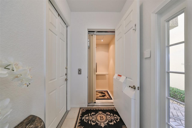 entryway with light tile patterned floors