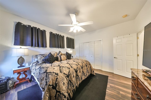 bedroom featuring ceiling fan, dark wood-type flooring, and a closet