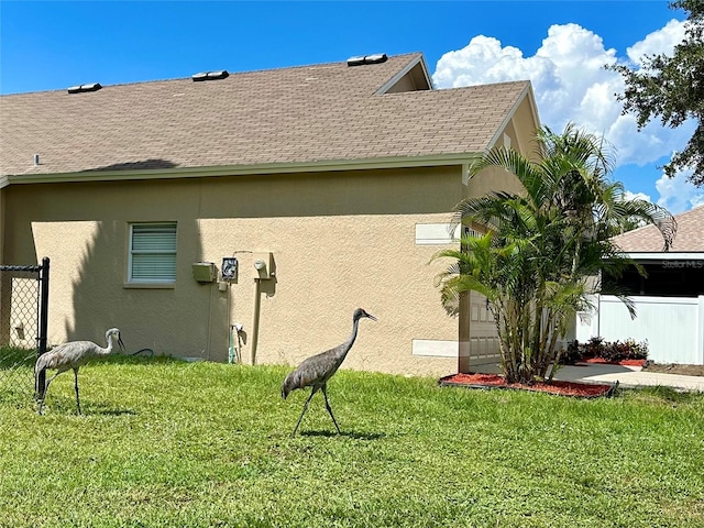 view of side of property with a lawn