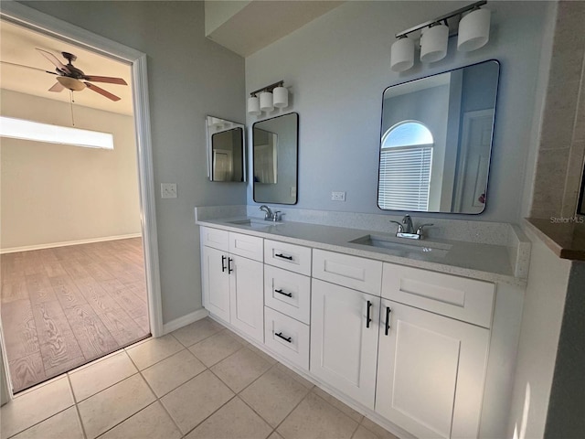 full bath with plenty of natural light, a sink, and tile patterned floors