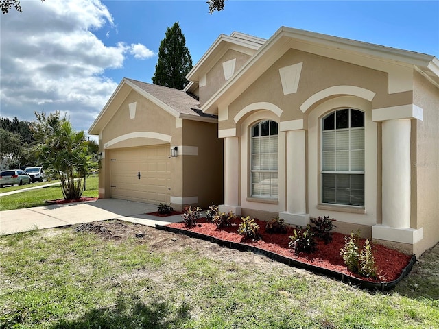 view of front of house featuring a garage and a front lawn