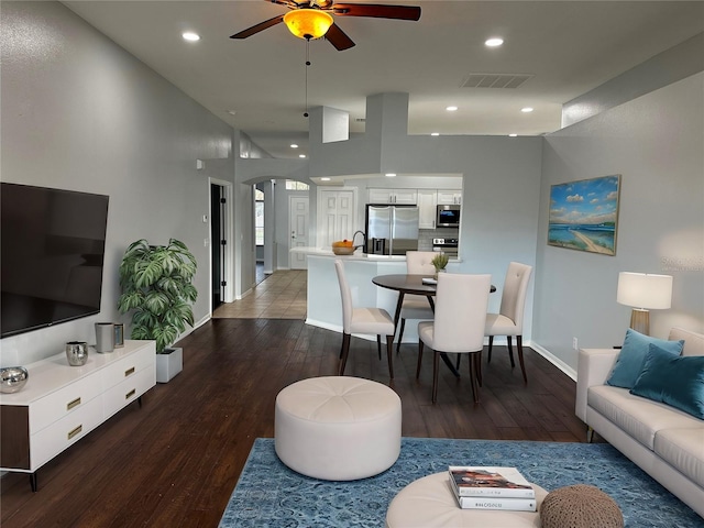 living room with arched walkways, recessed lighting, wood finished floors, a ceiling fan, and visible vents