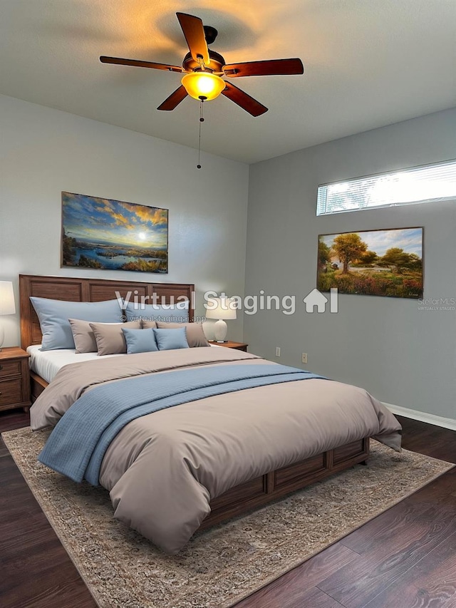 bedroom featuring baseboards, a ceiling fan, and dark wood-type flooring