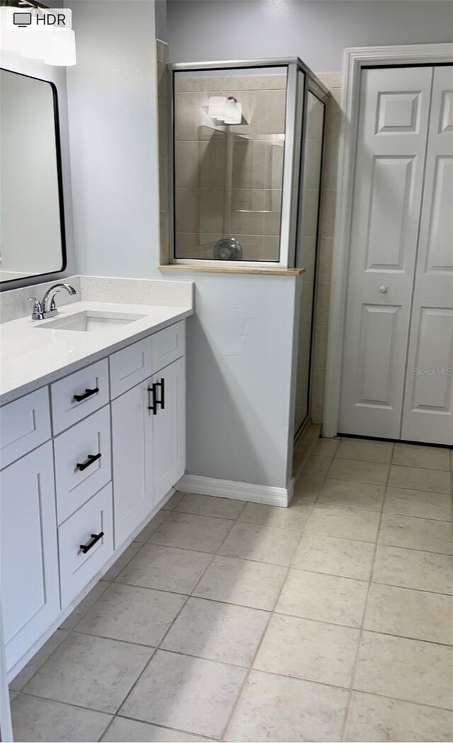 bathroom featuring a shower stall and vanity