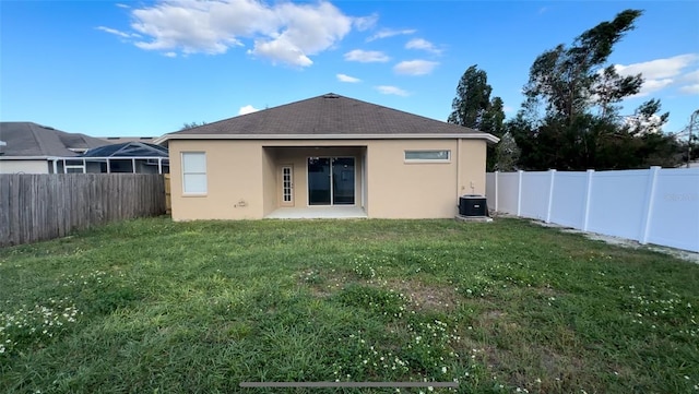 back of house with a yard, central air condition unit, stucco siding, a patio area, and a fenced backyard