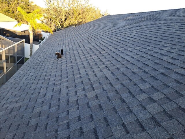 details featuring roof with shingles