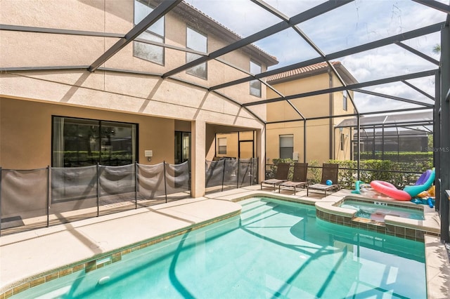 view of pool featuring an in ground hot tub, a lanai, and a patio area