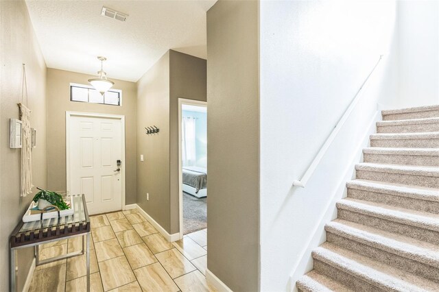 entrance foyer featuring a textured ceiling