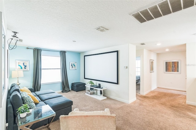 carpeted home theater featuring a textured ceiling