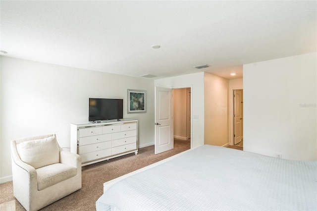 carpeted bedroom with a textured ceiling