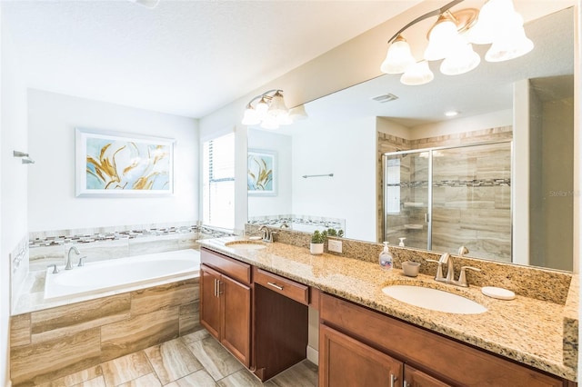 bathroom featuring plus walk in shower and vanity