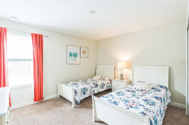 bedroom featuring light carpet