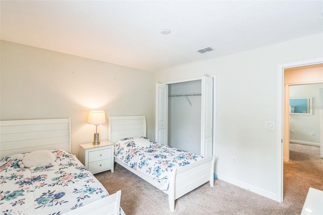 bedroom featuring a closet and carpet flooring