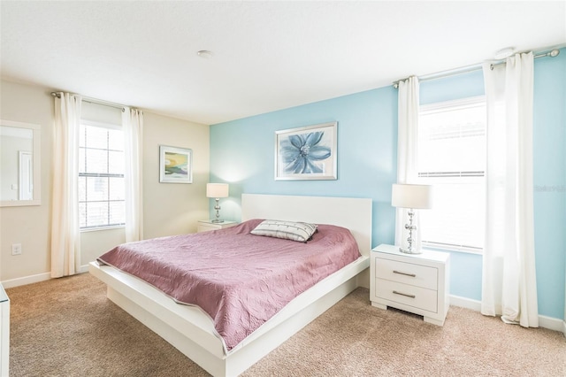 bedroom featuring light carpet