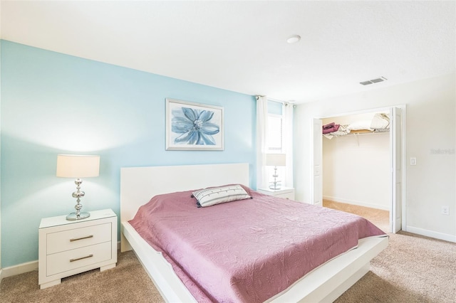 bedroom featuring light carpet and a closet