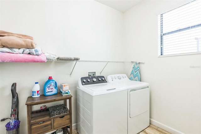 laundry room featuring light wood-type flooring and washing machine and dryer