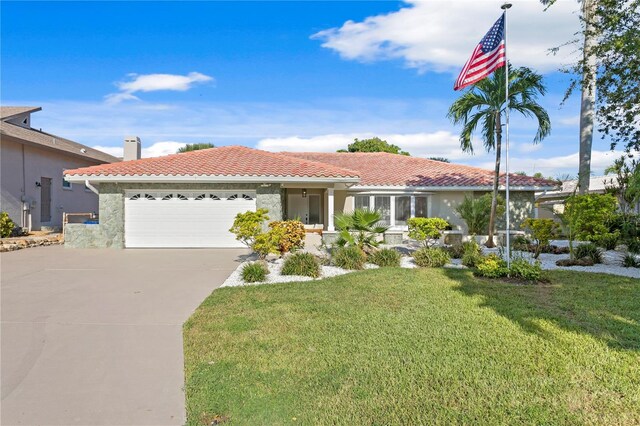 mediterranean / spanish-style house with a garage and a front yard