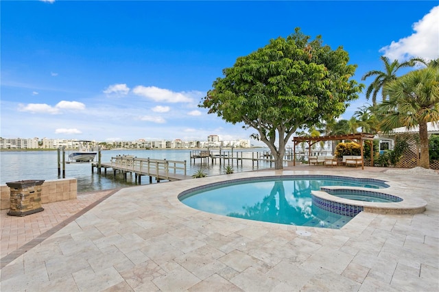 view of pool with a dock, a patio area, a water view, and an in ground hot tub