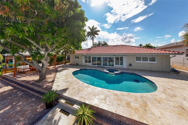 view of swimming pool with a patio and an in ground hot tub