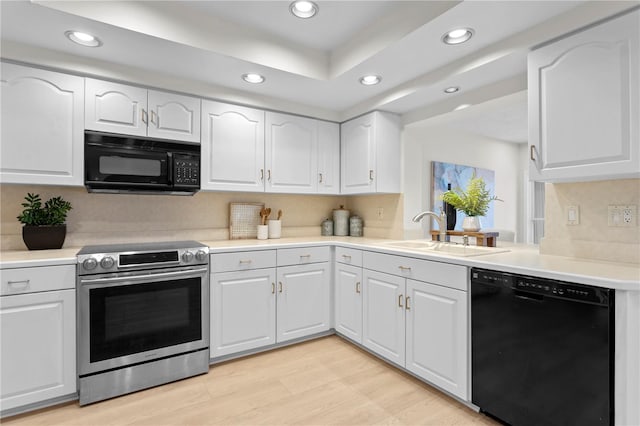 kitchen featuring black appliances, sink, light hardwood / wood-style floors, and white cabinets