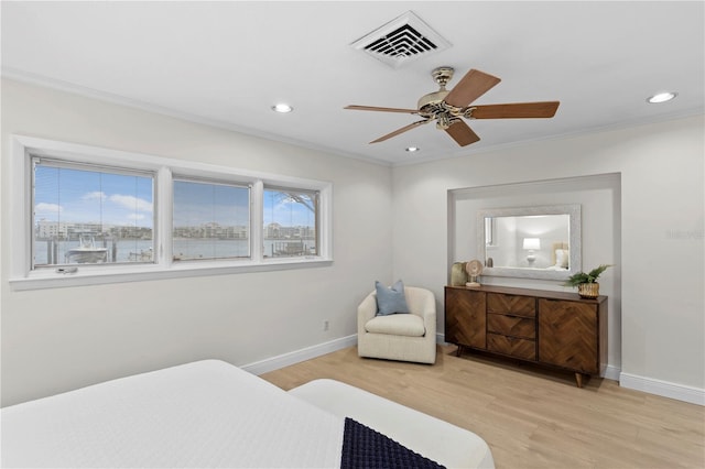 bedroom with ornamental molding, light hardwood / wood-style floors, and ceiling fan