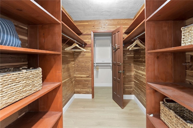 walk in closet featuring light hardwood / wood-style flooring