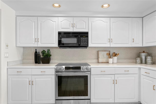 kitchen featuring black microwave, stainless steel electric range oven, white cabinetry, light countertops, and recessed lighting
