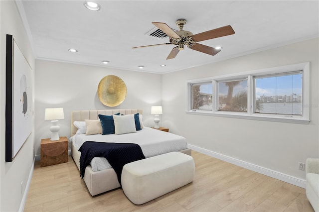 bedroom with ornamental molding, light hardwood / wood-style flooring, and ceiling fan